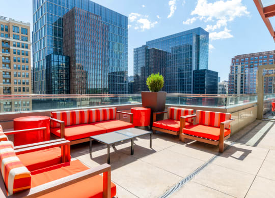 a rooftop patio with a view of the city and skyscrapers at The Acadia at Metropolitan Park, Arlington, VA
