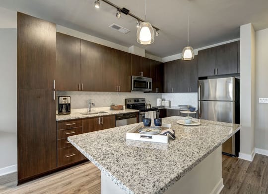 Kitchen with an island and stainless steel appliances at Highgate At The Mile in McLean 22102