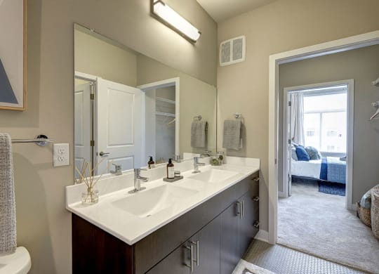 Bathroom with a large mirror and two sinks at Highgate at Highgate at the Mile, McLean, VA