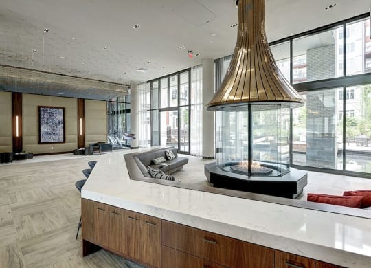 Lobby area with a large fireplace and natural light at Highgate at the Mile, McLean, VA