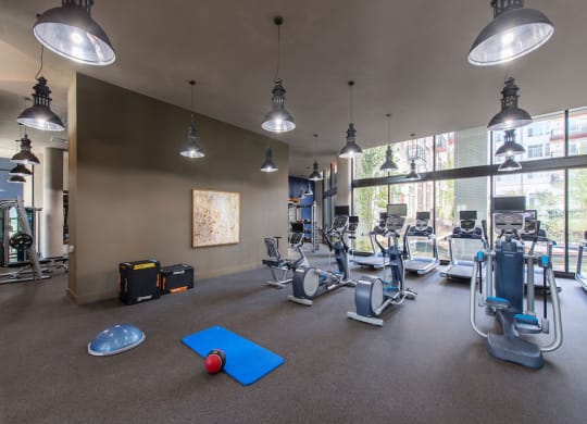 Fitness center with treadmills and other exercise equipment at Highgate at Highgate at the Mile, Virginia