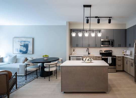 A modern kitchen with a dining table and chairs at Jayde Parkside Apartments, Washington DC