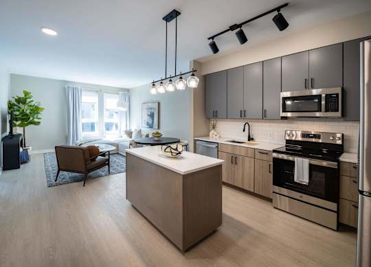A modern kitchen with a wooden island and stainless steel appliances at Jayde Parkside Apartments, Washington, Washington DC