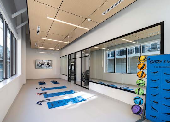A yoga studio with blue mats and a sign at Jayde Parkside Apartments, Washington 20019