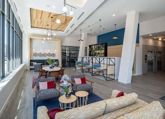 A modern living room with a large couch and a dining table at Jayde Parkside Apartments, Washington DC