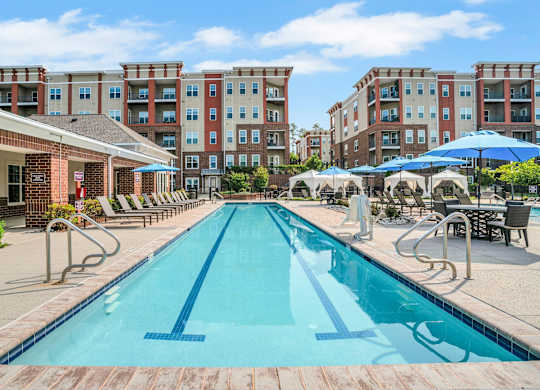 Pool With Relaxing Chairs at The Aster Cary, Cary