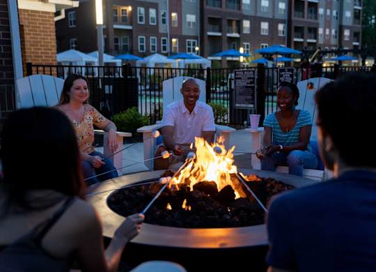 Group of Residents Seated Around Fireplace at The Aster Cary, Cary North Carolina