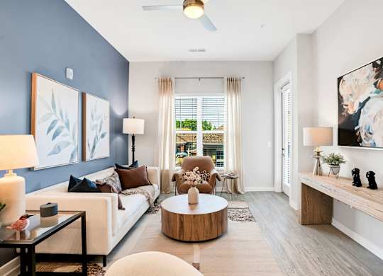 A Living Room With a White Couch at The Aster Cary, Cary North Carolina