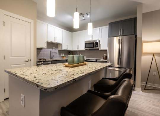A Kitchen With Refrigerator at The Aster Cary, Cary
