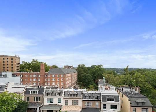 A view of a cityscape with buildings and trees.
