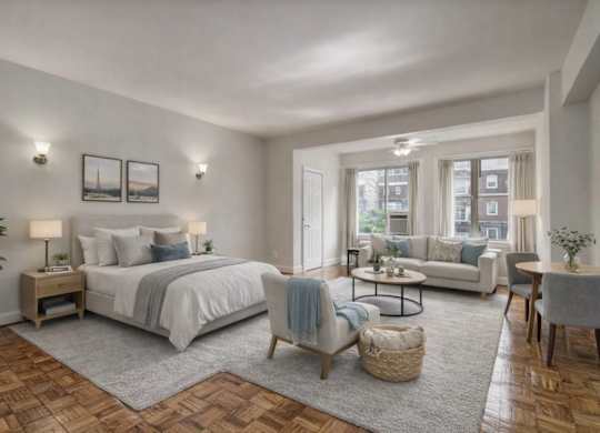 A well-lit bedroom with a large bed, a couch, and a coffee table.