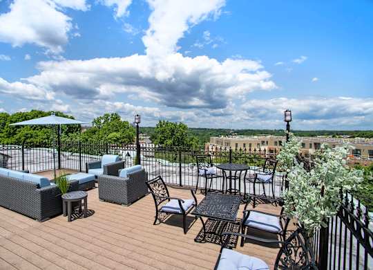 A patio with furniture and a view of the city.