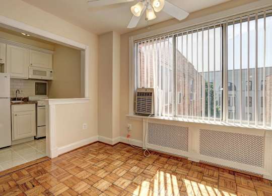 A sunny kitchen with a fan and a window.