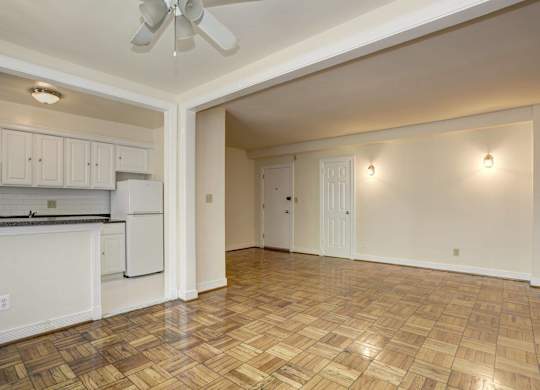 Open floor plan with parquet flooring and kitchen at Tivoli Gardens Apartments, Washington, DC