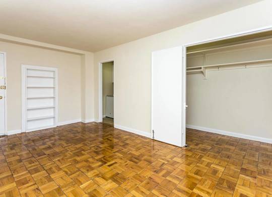 A room with a wooden floor and white walls.