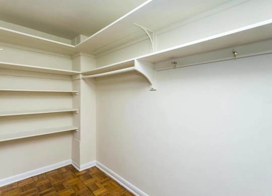 A room with white walls and a wooden floor.