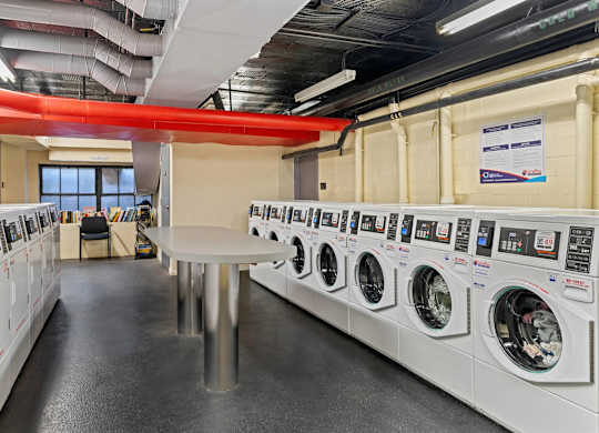 A row of washing machines in a public laundromat.