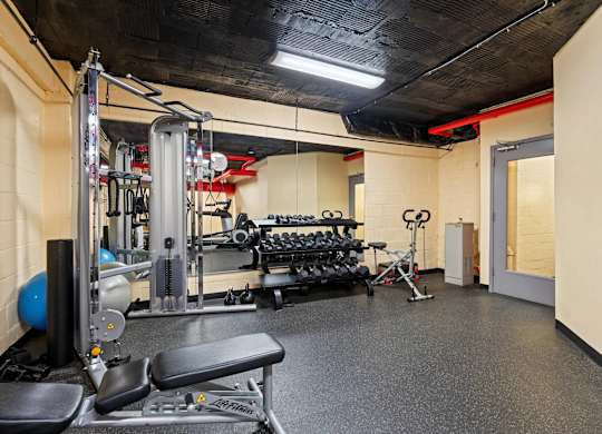 A gym with a variety of equipment including a leg press machine.