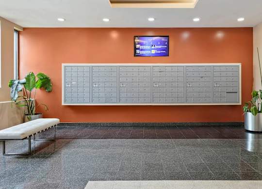 A wall with a calendar on it and a TV above it.