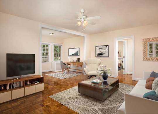 A living room with a white couch, a wooden coffee table, and a flat screen TV.