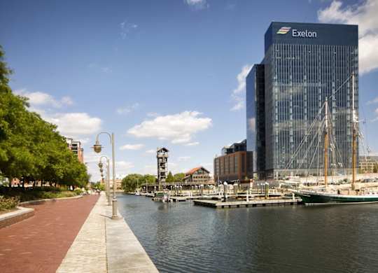 Waterfront promenade with marina and high rise building at 1305 Dock Apartments, Baltimore, MD