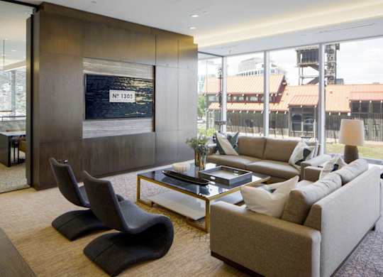 Modern living room with sectional sofa and entertainment center at 1305 Dock Apartments, Baltimore, MD 21231