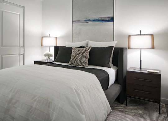 Modern bedroom with dark headboard and nightstands at 1305 Dock Apartments, Maryland, 21231