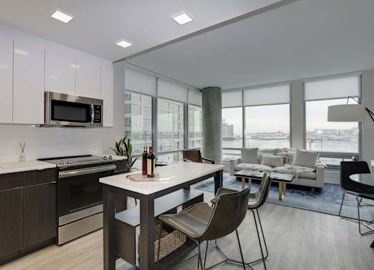 Modern open concept apartment with kitchen island at 1405 Point Apartments, Baltimore