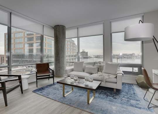 Modern living room with floor to ceiling windows at 1405 Point Apartments, Baltimore, Maryland