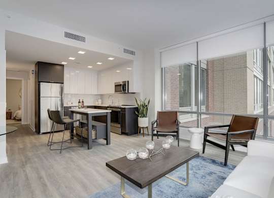 Open concept apartment with kitchen and seating area at 1405 Point Apartments, Baltimore, MD