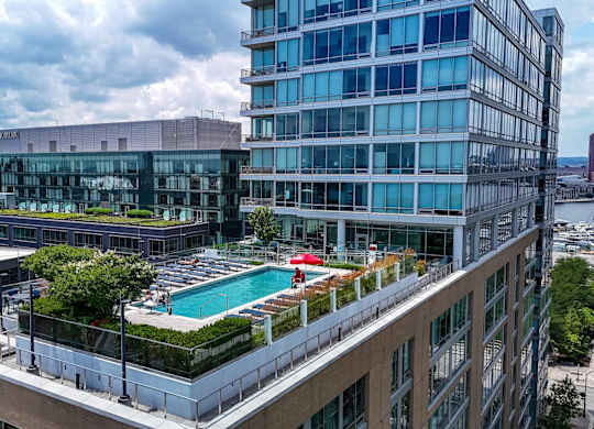 Rooftop pool deck with modern high rise buildings at 1405 Point Apartments, Baltimore, 21231