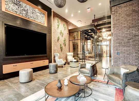 A modern living room with a flat screen TV and comfortable seating.