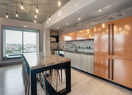 A modern kitchen with a wooden island and stainless steel appliances.