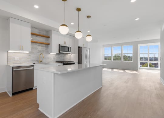 a large white kitchen with an island and stainless steel appliances at Rialto, Washington, DC