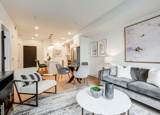a living room with a gray couch and a white table at Rialto, Washington 
