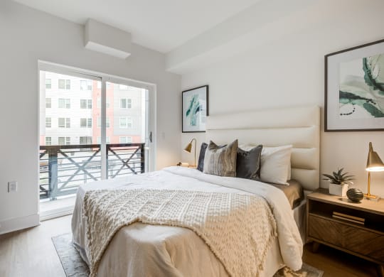a bedroom with a bed and a sliding glass door to a balcony at Rialto, Washington District of Columbia