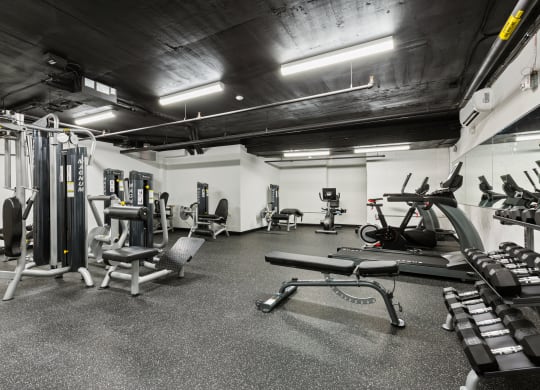a gym with weights and other equipment in a building with black ceilings at Rialto, Washington, 20002