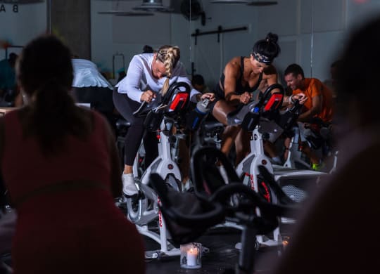 a group of people riding exercise bikes in a gym at Allied Harbor Point, Baltimore, MD, 21231
