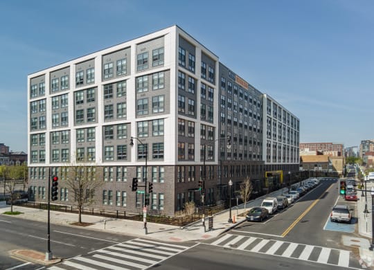 a large white building on the corner of a city street