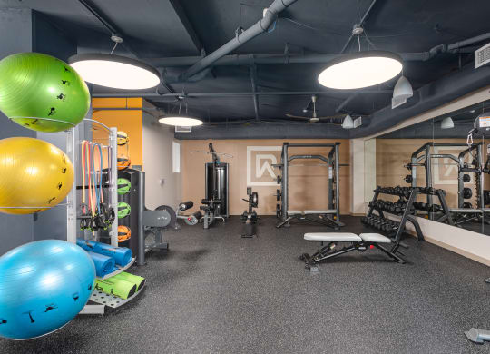 a workout room with weights and other gym equipment
