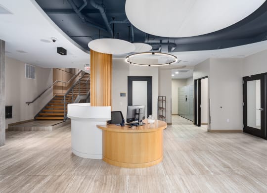 a lobby with a reception desk and a staircase