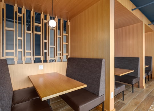 a dining room with wooden walls and a table and chairs