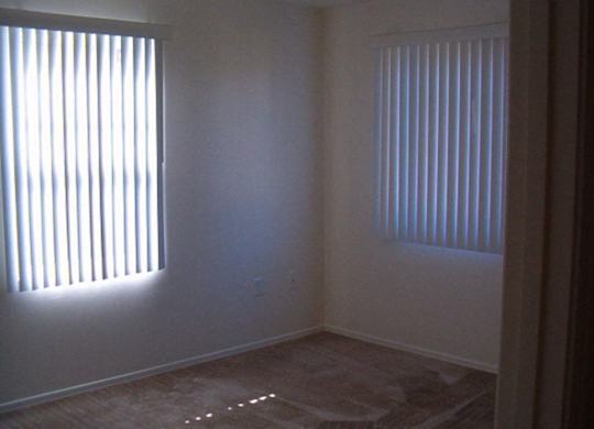 A room with a window on the left and a window on the right at Roosevelt Commons Apartments, Phoenix, AZ