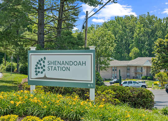 A sign that says Shenandoah Station in front of a building.