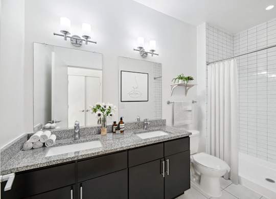 a bathroom with two sinks and a shower and a toilet at Fort Totten Square, Washington, 20011