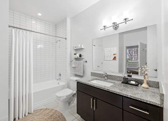 a white bathroom with a shower and a sink at Fort Totten Square, Washington DC