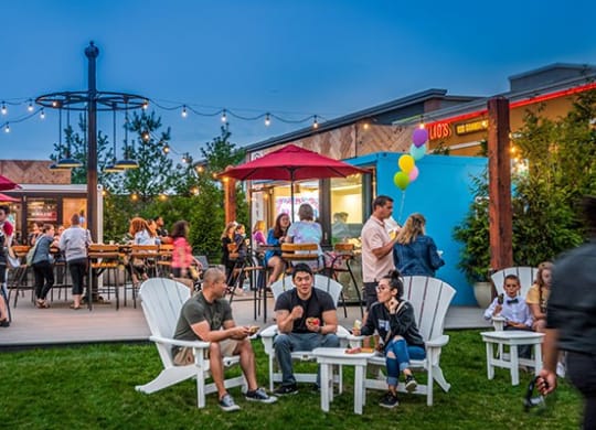 a group of people sitting and standing around a patio at Vyne One Loudoun, Ashburn, Virginia