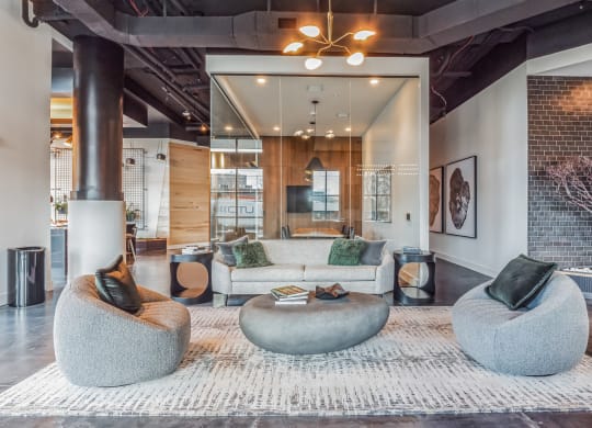 a living room with couches and chairs and a rug at South and Hollis, Charlotte