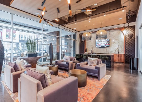 the lobby of a building with couches and chairs at South and Hollis Apartments, North Carolina