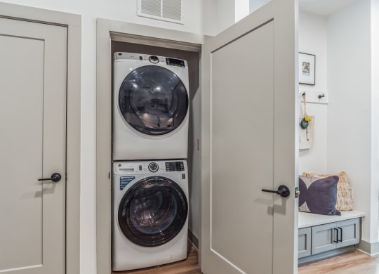 a small laundry room with a washer and a dryer at South and Hollis, Charlotte